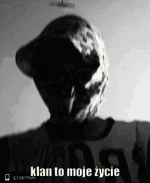 a black and white photo of a person with a mask on their face and the words `` klan to moje zycie '' .