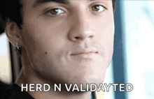 a close up of a man 's face with the words herd n validated written below him .