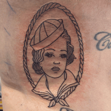 a tattoo of a sailor with a rope around her neck