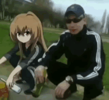 a man and a girl from a anime are squatting down in the grass .