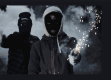 a man wearing a mask is holding a firework