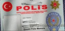 a close up of a turkish national police identity card with a blue badge .