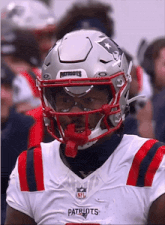 a patriots football player wears a helmet with the word patriots on the front