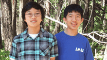 two boys standing next to each other one wearing a shirt that says jmjs