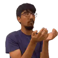 a man with glasses and a beard is clapping