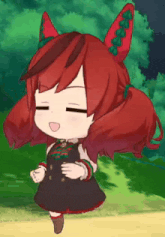 a little girl with red hair and green ears is dancing .