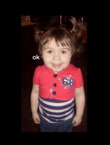 a little girl wearing a red shirt with 68 on it