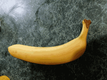 a banana is sitting on a green counter top