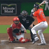 a baseball player with the number 2 on his back is swinging a bat
