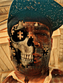 a man wearing a hat has a skull made out of puzzle pieces covering his face