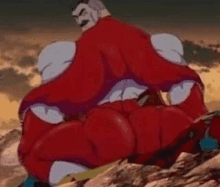 a man in a red suit is sitting on top of a mountain .