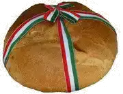 a loaf of bread with a red , white , and green ribbon around it .