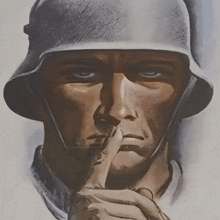 a man in a helmet holds his finger to his lips