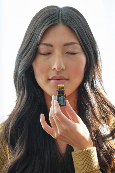 A woman smelling essential oil