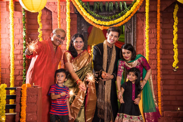 Indian Family celebrating Diwali festival with fire crackers Indian Family celebrating Diwali festival with fire crackers diwali kids stock pictures, royalty-free photos & images