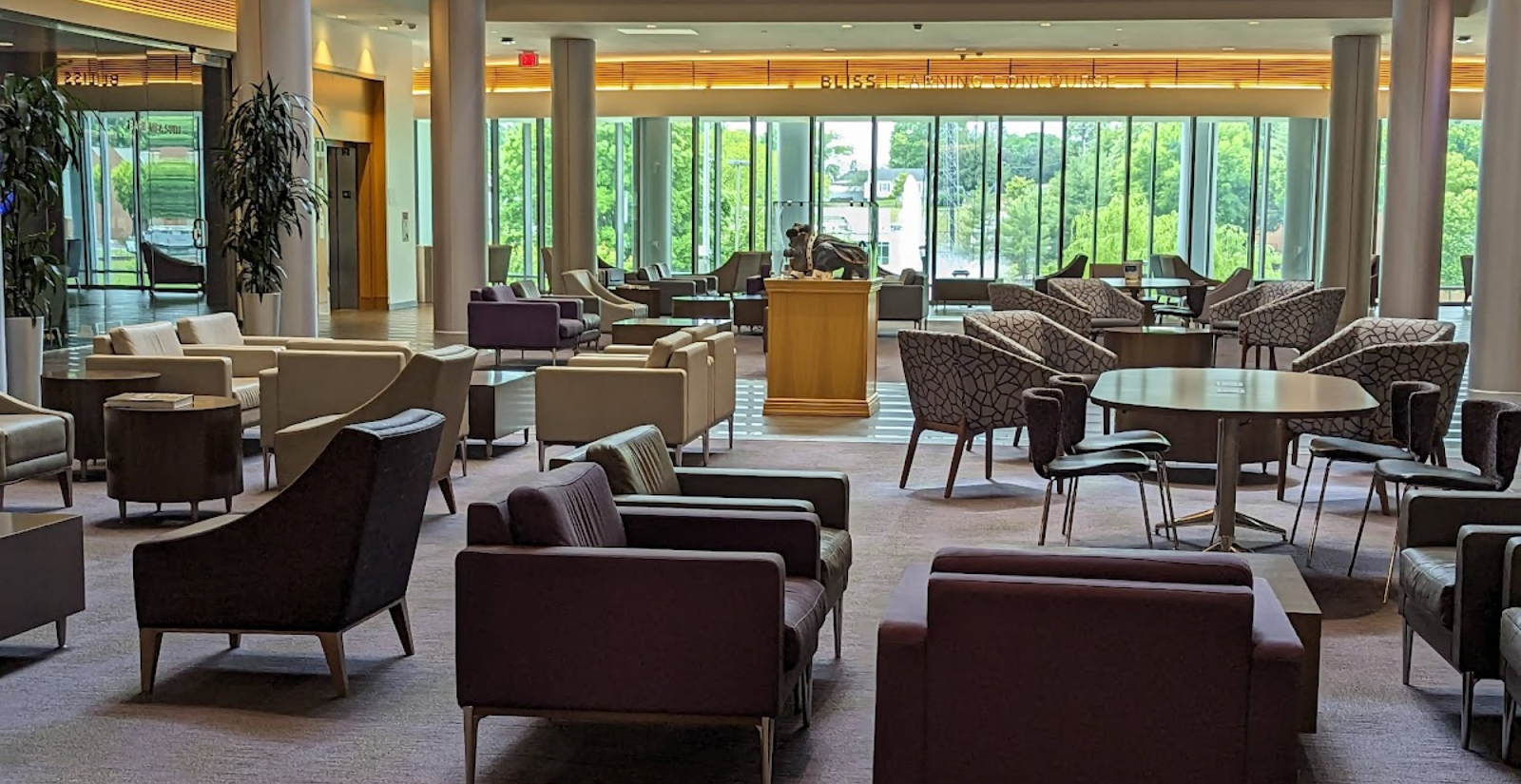 brightly lit atrium filled with chairs and couches