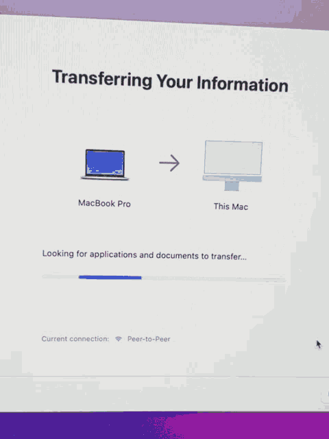 a screen that says transferring your information with a laptop and a monitor