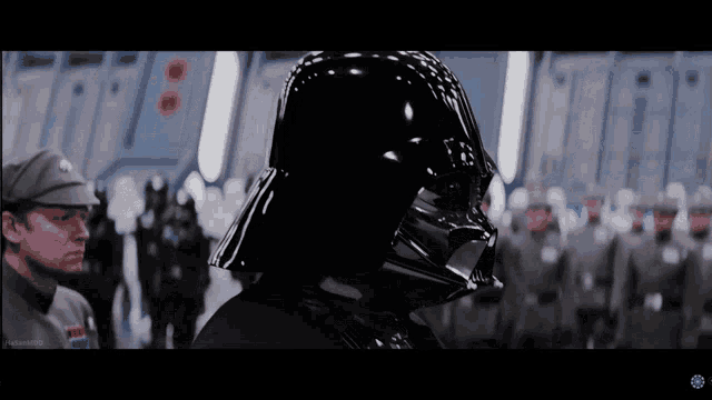 darth vader stands in front of a row of soldiers