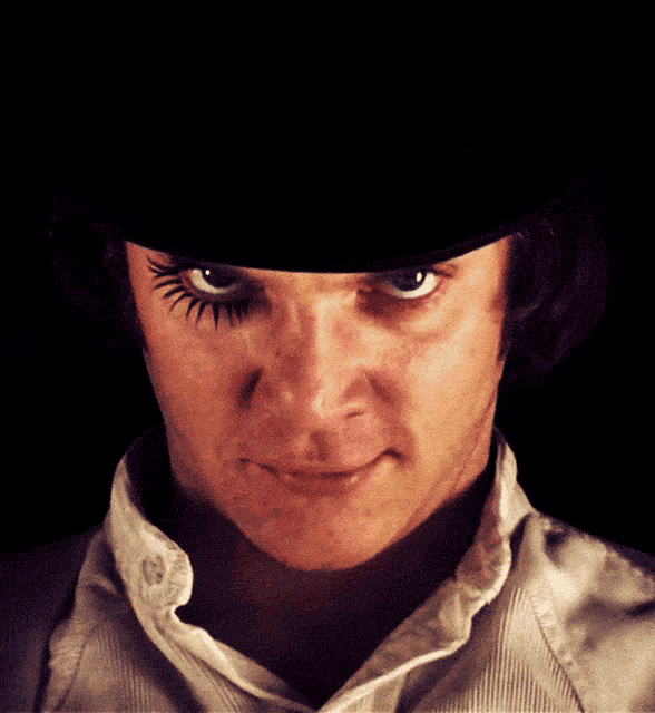 a close up of a man 's face with a hat on