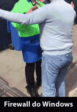 a man in a blue sweater is standing next to a woman in a green vest with the words firewall do windows below them