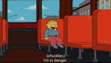 a cartoon character is sitting in an empty bus with the words " chuckles i 'm in danger "