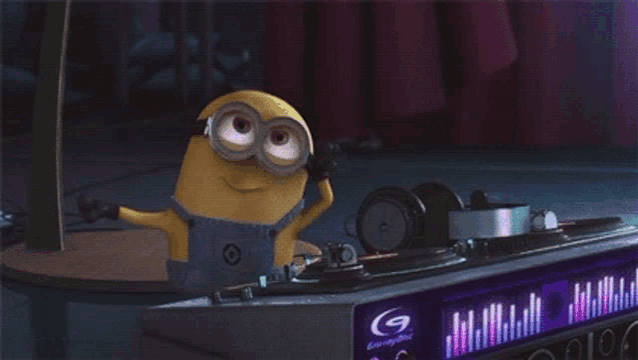 a cartoon minion is playing music on a turntable .