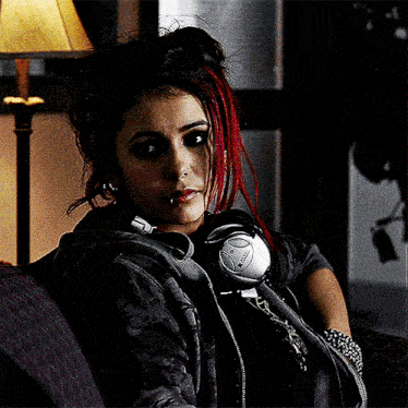 a woman with red hair is wearing a pair of headphones with the word bose on them