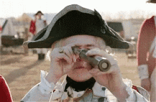 a man in a colonial hat is looking through a telescope .