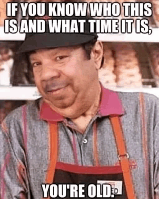 a man wearing an apron and a hat is standing in front of a shelf with a meme on it .