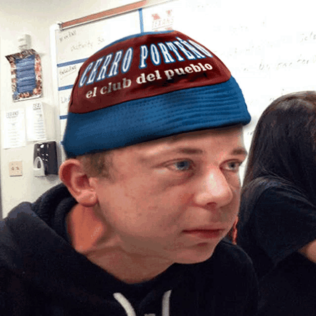 a young man wearing a hat that says cerro porters el club del pueblo