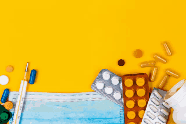 a thermometer is surrounded by pills and a mask on a yellow background