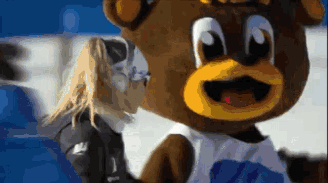 a teddy bear wearing a blue and white shirt with the number 26