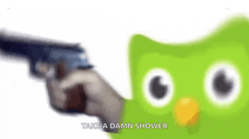 a person is pointing a gun at a green cartoon owl .