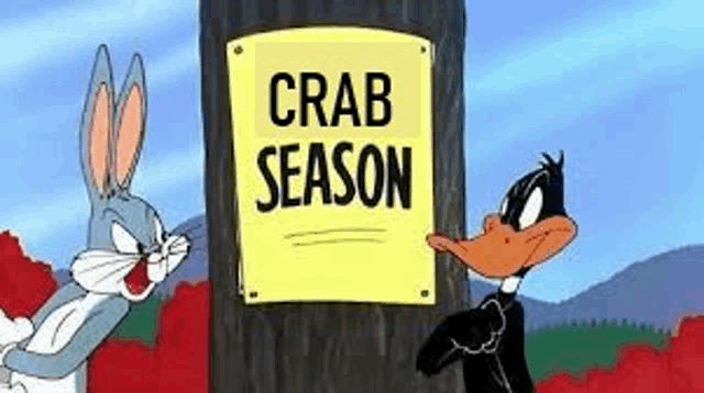 bugs bunny and daffy duck are standing in front of a sign that says crab season .