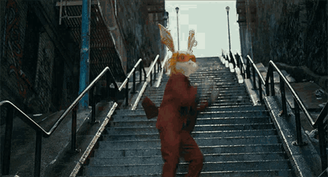 a person in a rabbit mask is walking up stairs