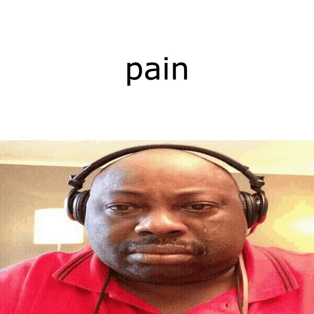 a man wearing headphones with the word pain written above him