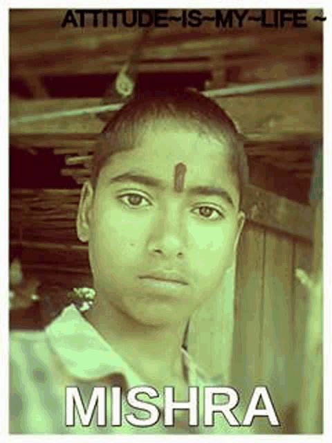 a young boy with a red dot on his forehead and the name mishra on the bottom