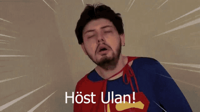 a man with a beard is wearing a cape with the words host ulan on the bottom