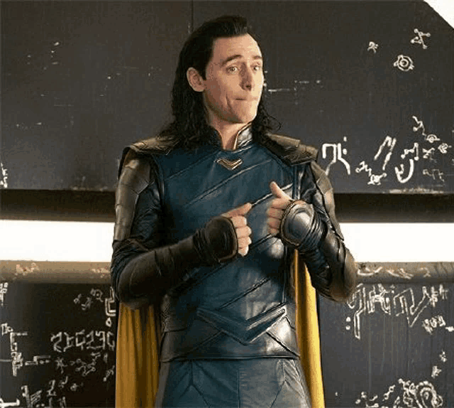 loki from avengers : age of ultron is standing in front of a blackboard and giving a thumbs up .