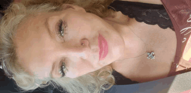 a close up of a woman 's face with a red lip