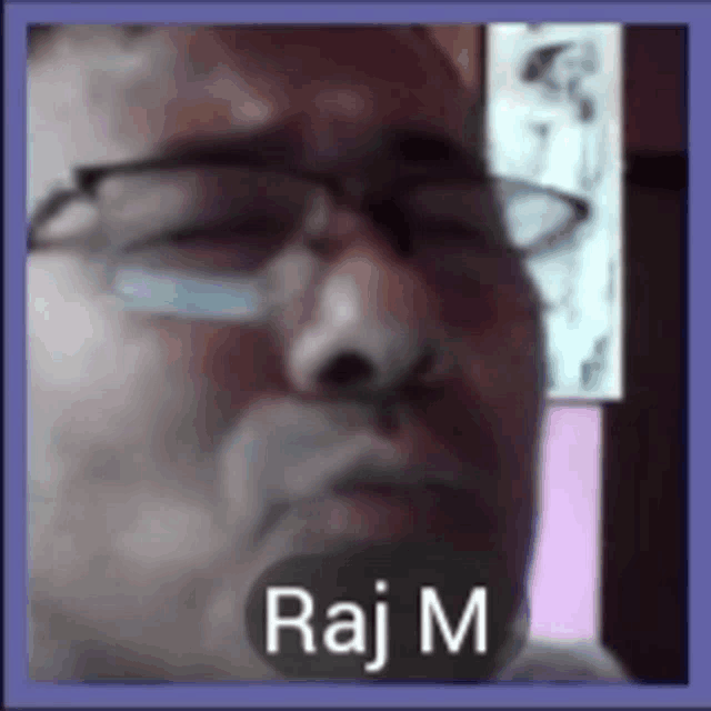 a close up of a man 's face with the name raj m on it