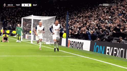 a soccer game is being played in front of a crowd with an ad for hankook