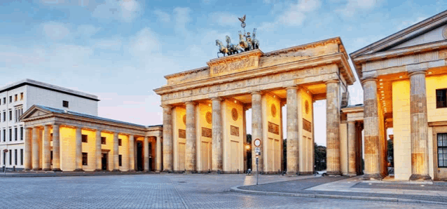 a large building with columns and a horse on top of it is called the berlin gate .