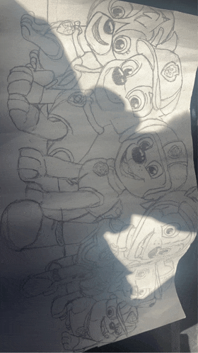 a drawing of a group of paw patrol characters on a piece of paper