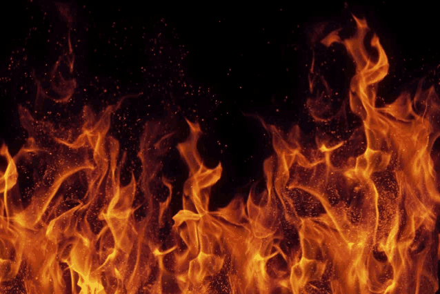 a close up of a fire on a dark background