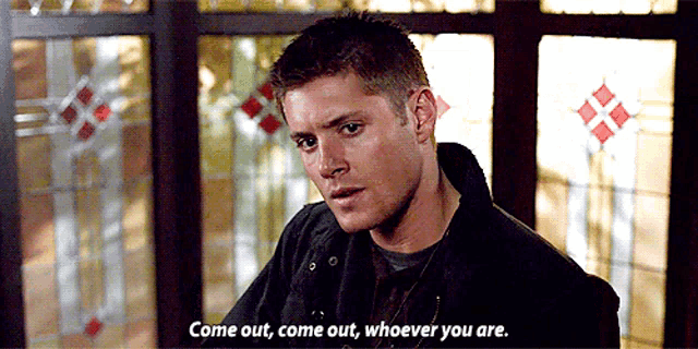 a man is standing in front of a stained glass window and says come out come out whoever you are