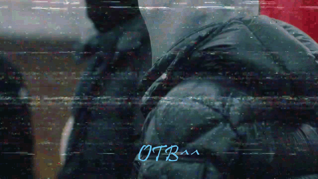 a blurry picture of a person with the word otbaa written below them
