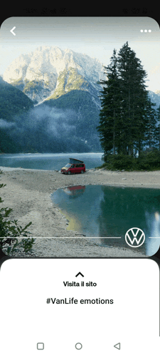 a volkswagen van is parked on a beach near a lake