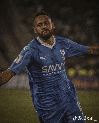 a soccer player wearing a blue shirt that says savvy games group