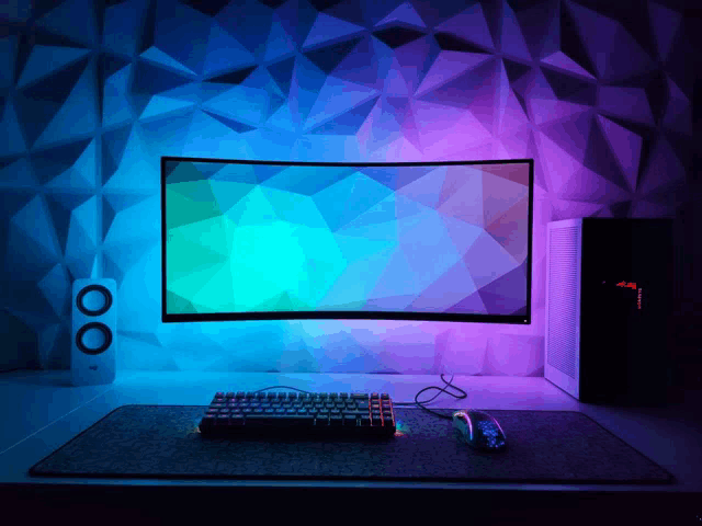 a computer monitor with a colorful background and a keyboard and mouse